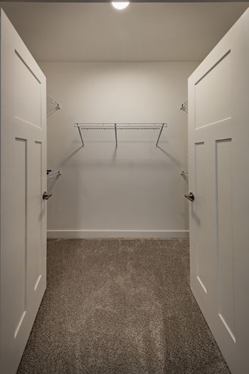 Spacious closet space with french doors and wire shelving at Wesley Place Apartments in Indianapolis, IN